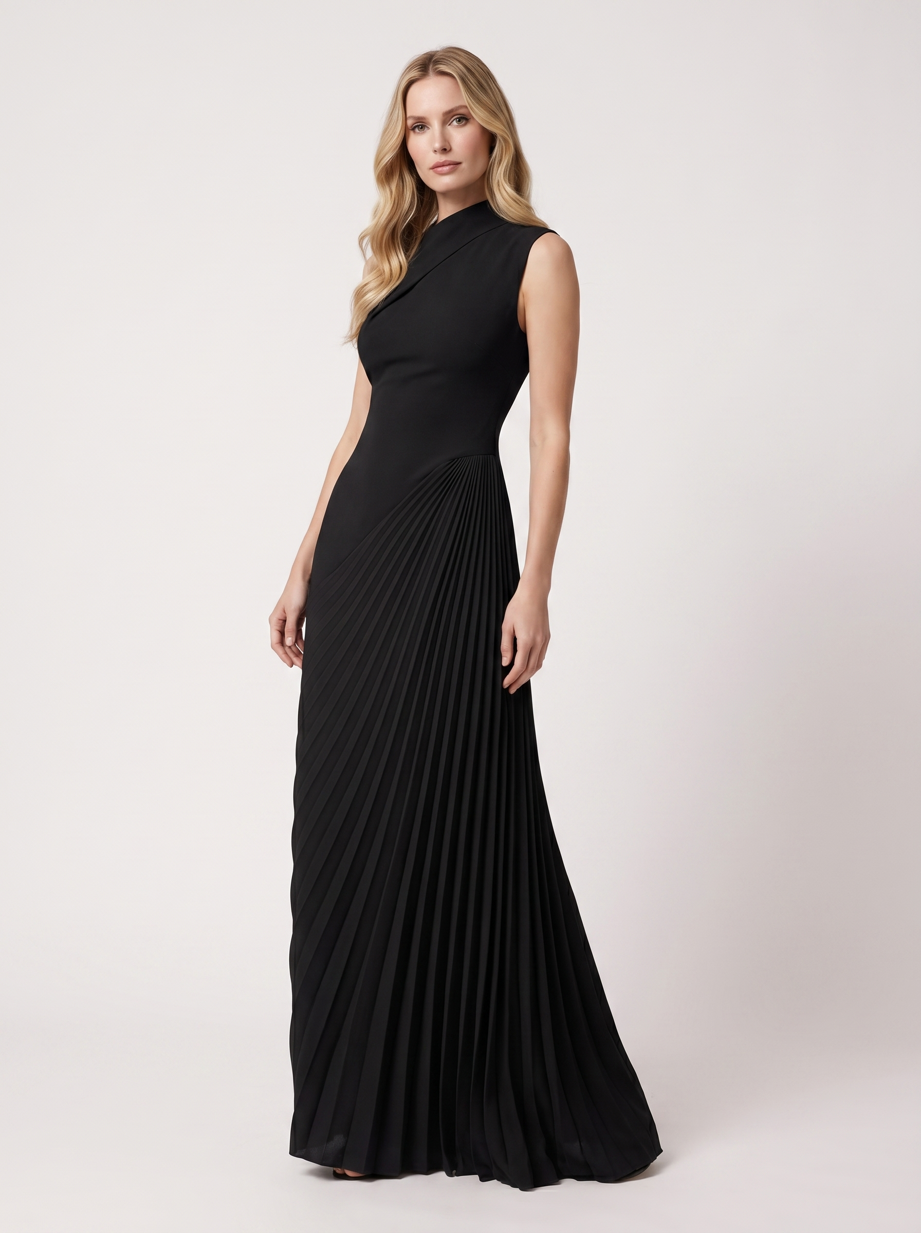 Black one-shoulder pleated maxi dress, three-quarter view showing draped pleats and long skirt