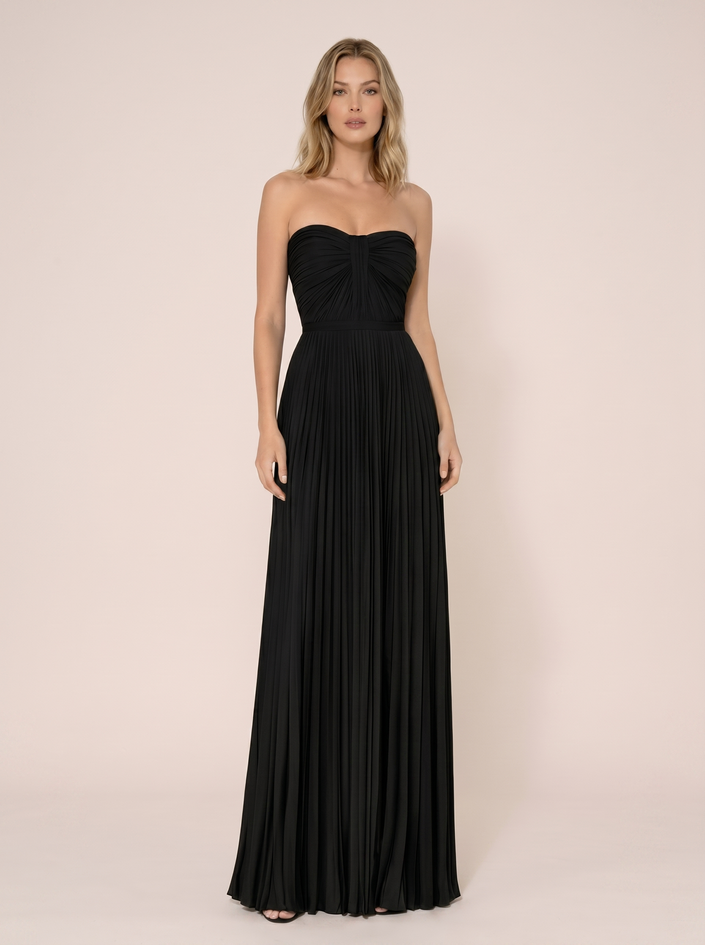 Black strapless pleated wedding guest maxi dress with structured bodice, front view on model