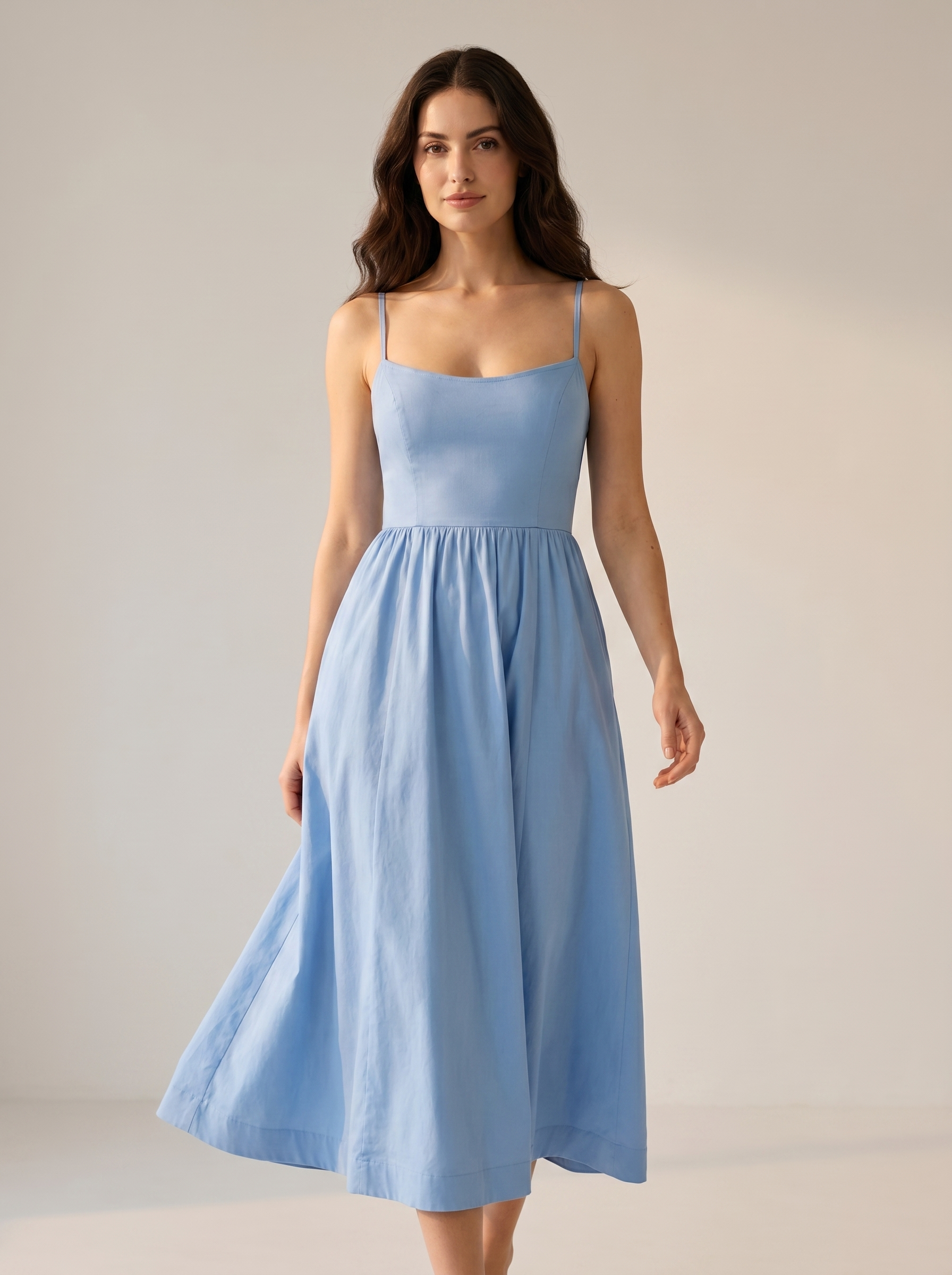 Blue A-line wedding guest midi dress, full-length view of model in a bright studio setting