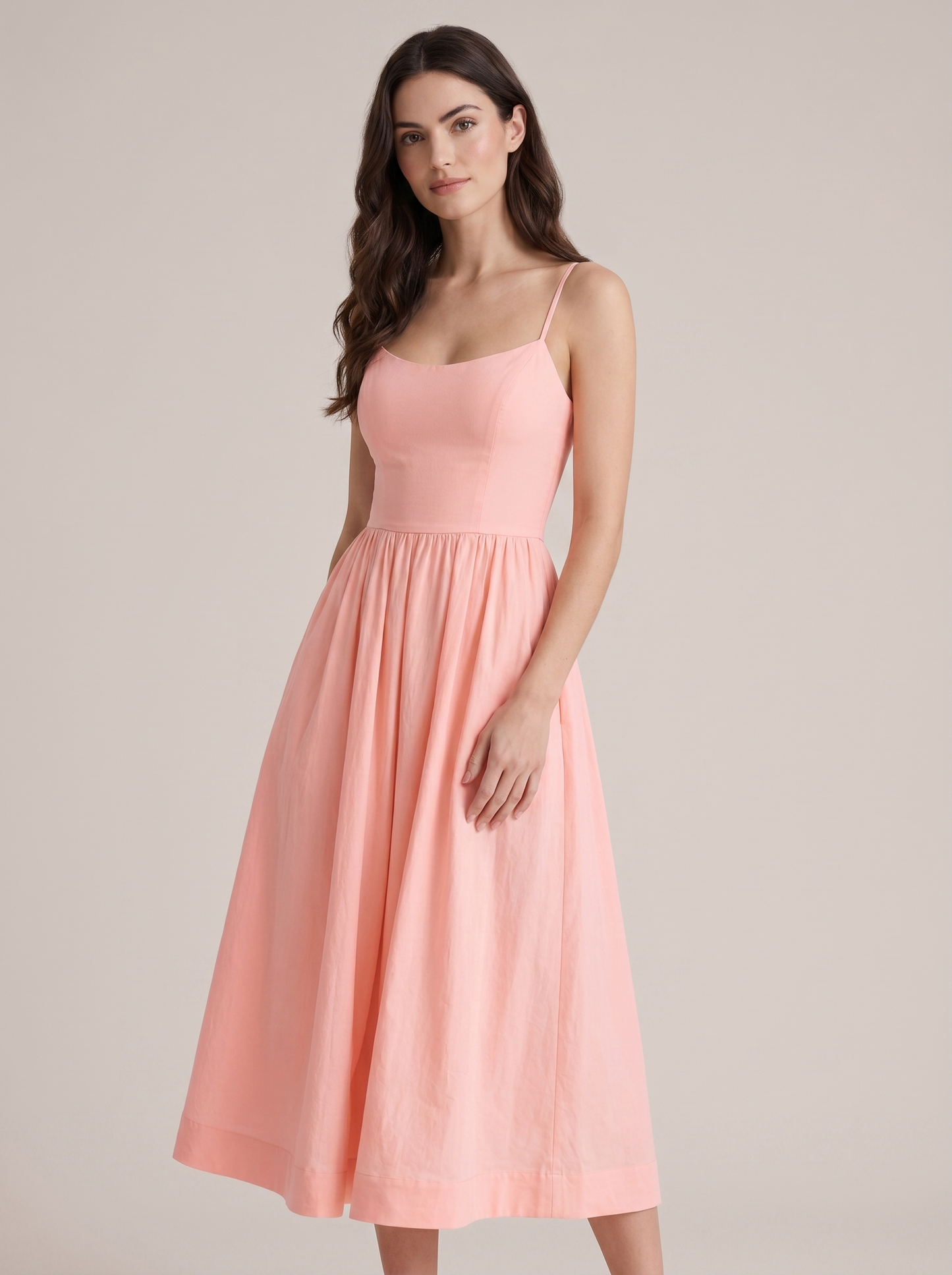 Pink A-line wedding guest midi dress, three-quarter view showing fitted waist and flared skirt