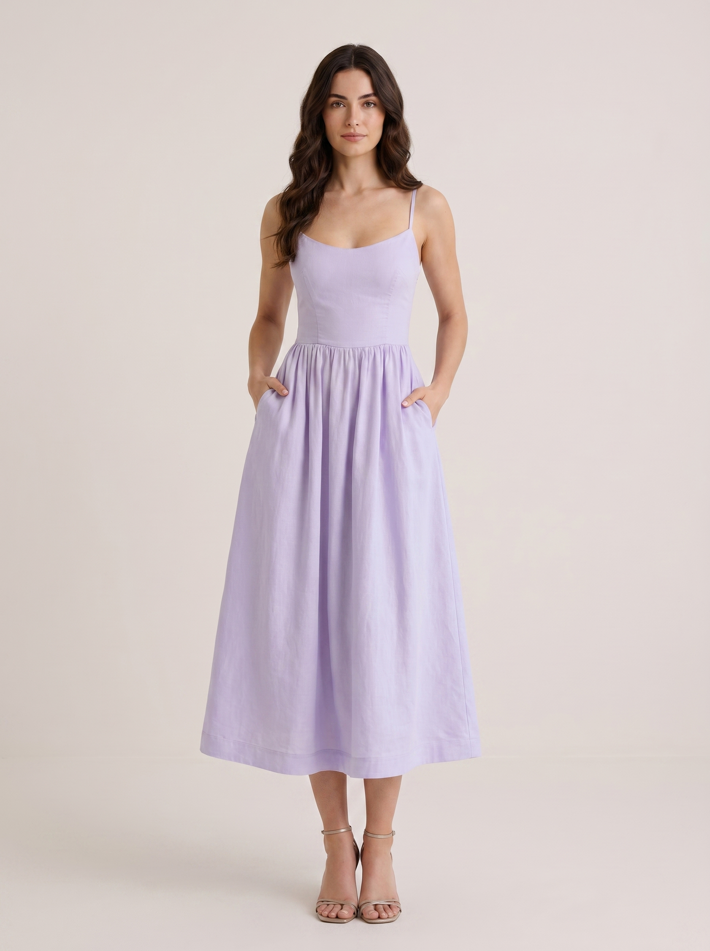 Purple A-line wedding guest midi dress with thin straps and fitted bodice, front view on model