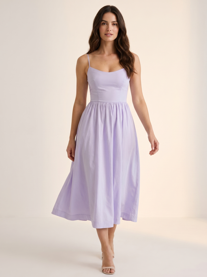 Purple A-line wedding guest midi dress, full-length view of model in a bright studio setting